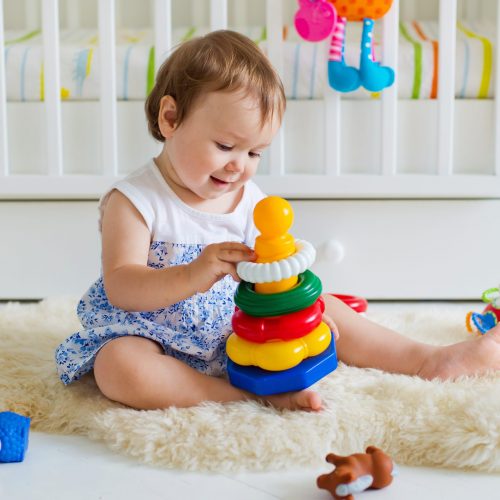 baby-girl-playing-with-educational-toy-nursery (1)
