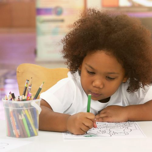 Little African girl painting and drawing with happiness.